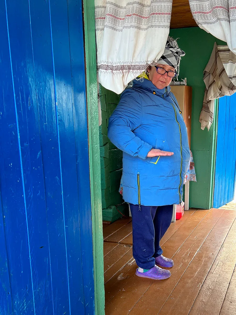 Victoria Ludannaya demonstrates the height of the tiger who ran into her house. Photo by Irina Kravtsova / Novaya Gazeta Europe