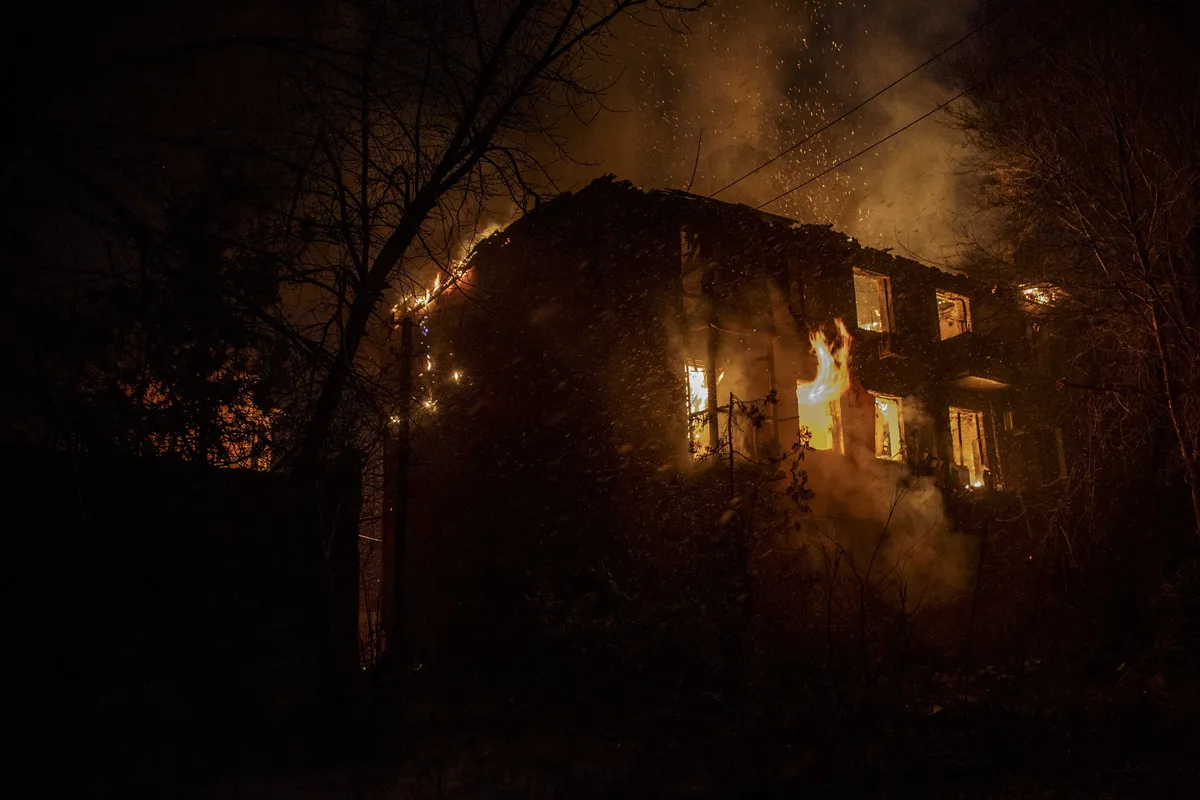 A fire broke out on a building after Russian shelling as military mobility continues within the Russian-Ukrainian war in Bakhmut, Ukraine on February 15, 2023. Photo: Marek M. Berezowski / Anadolu Agency / Getty Images