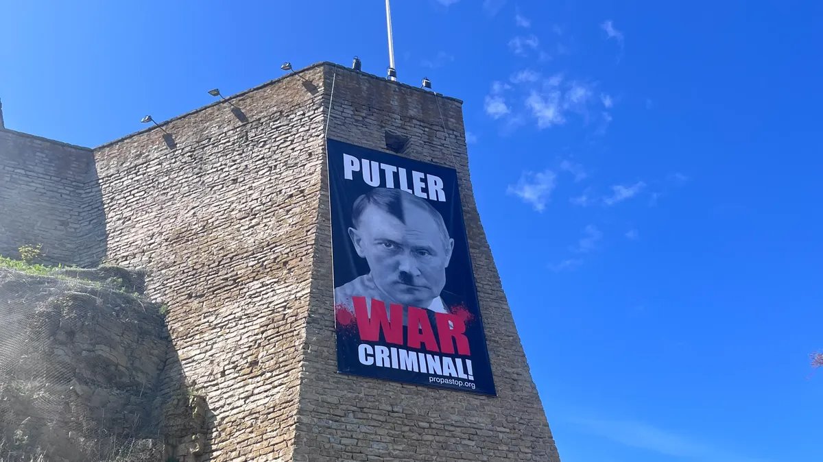A poster on the Narva Fortress, Estonia, on 9 May 2025. Photo: Jack Styler