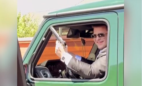Adam Kadyrov fires a gun into the air in a limited-edition Mercedes-Benz G-Class. Screenshot from a video posted on social media