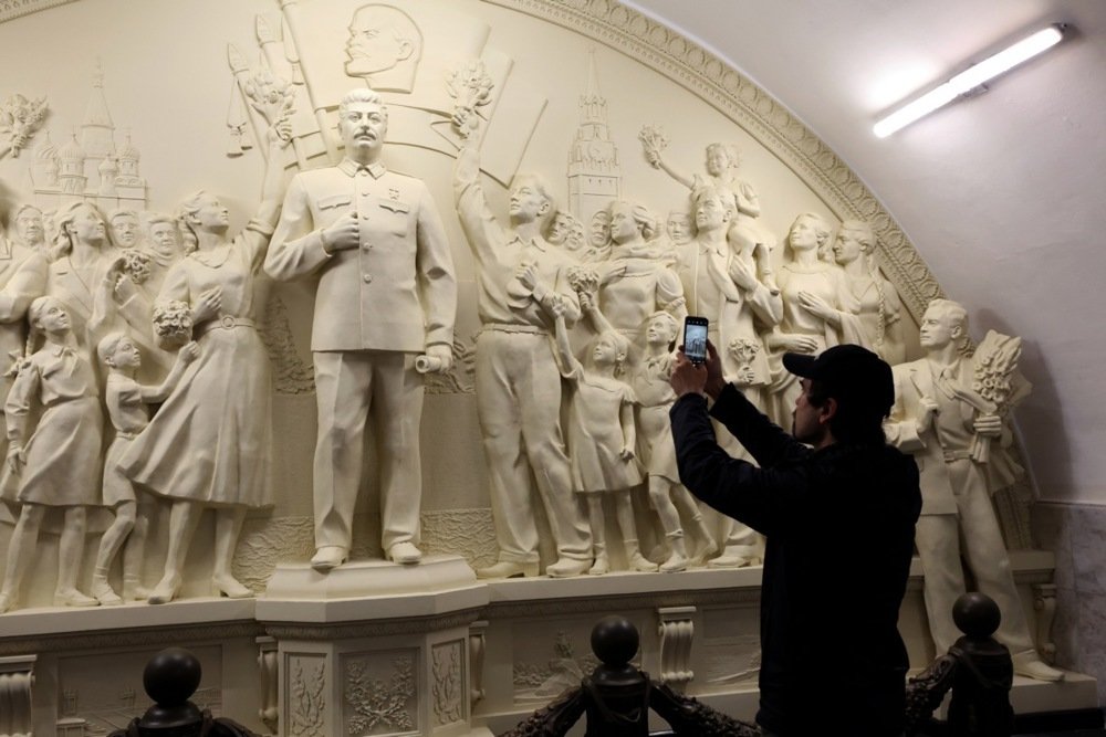 A man takes a photo of the bas-relief sculpture featuring Soviet leader Joseph Stalin at the Taganskaya metro station in Moscow on 15 May 2025. Photo: EPA-EFE/MAXIM SHIPENKOV