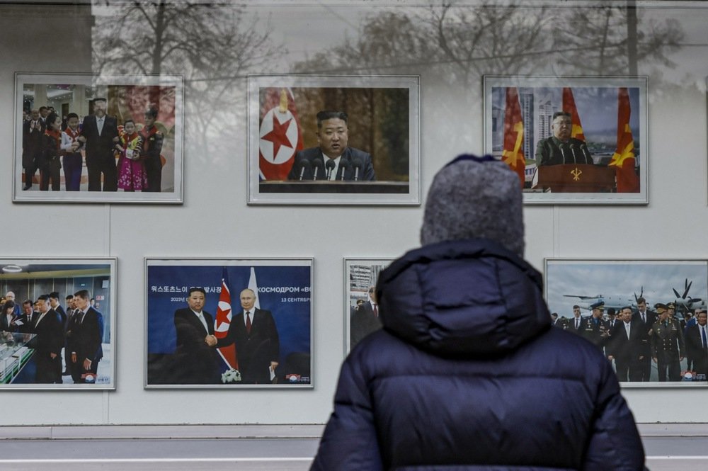 A person looks at photos of North Korean leader Kim Jong Un, outside of the North Korean Embassy in Moscow, Russia, 30 October 2024. Photo: EPA-EFE/YURI KOCHETKOV