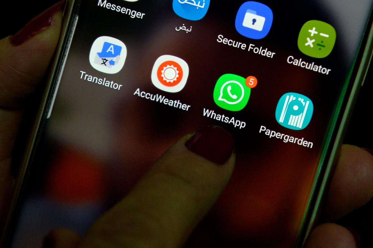A woman uses the WhatsApp application on her cell phone. Photo: EPA/WAEL HAMZEH
